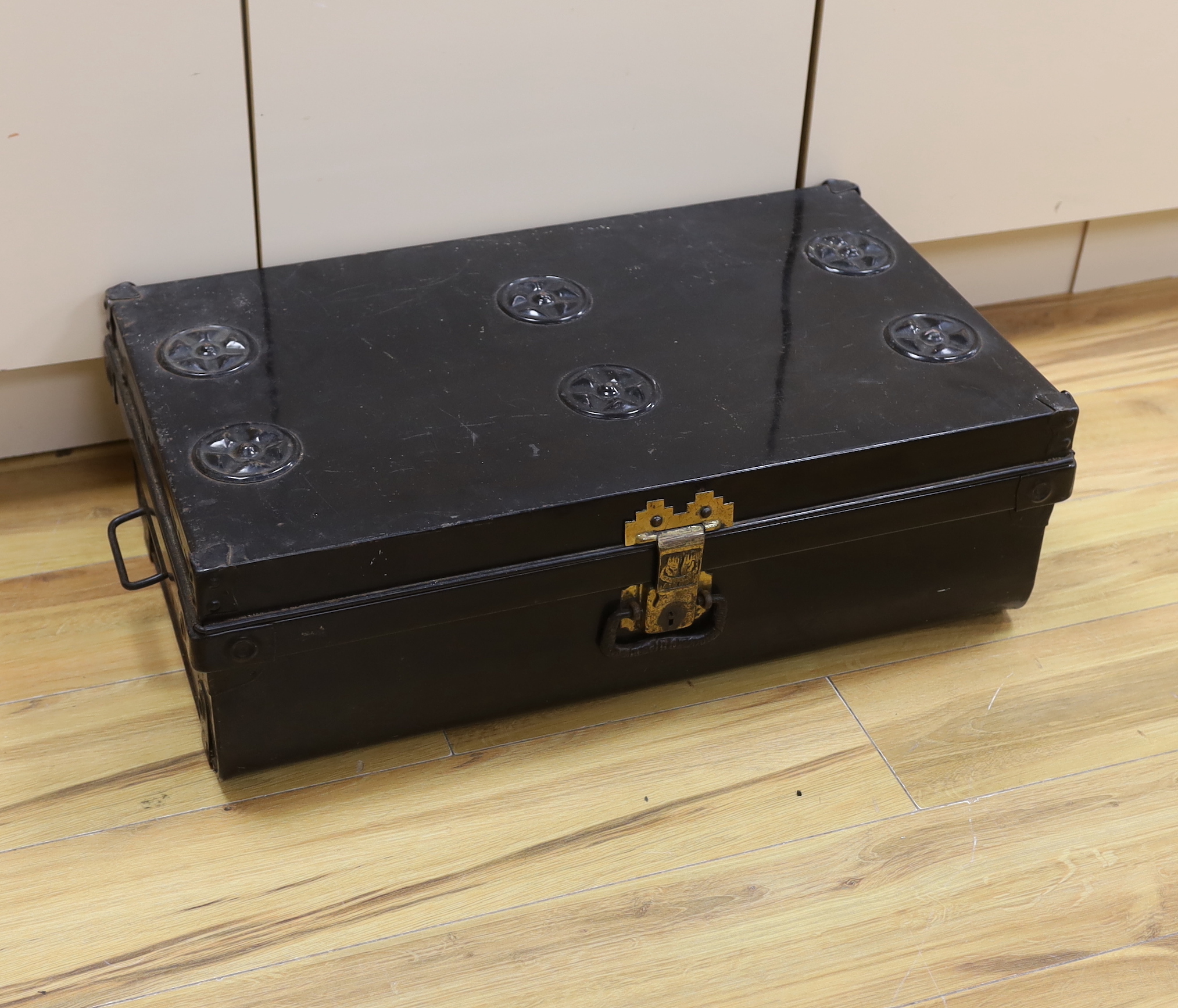 A black lacquered tin trunk, 68cm wide